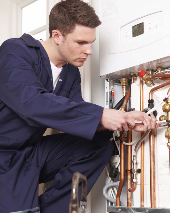 Engineer Servicing Central Heating Boiler