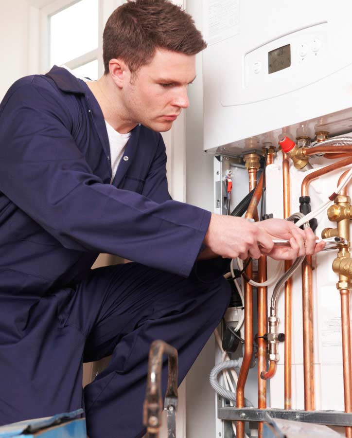 Engineer Servicing Central Heating Boiler