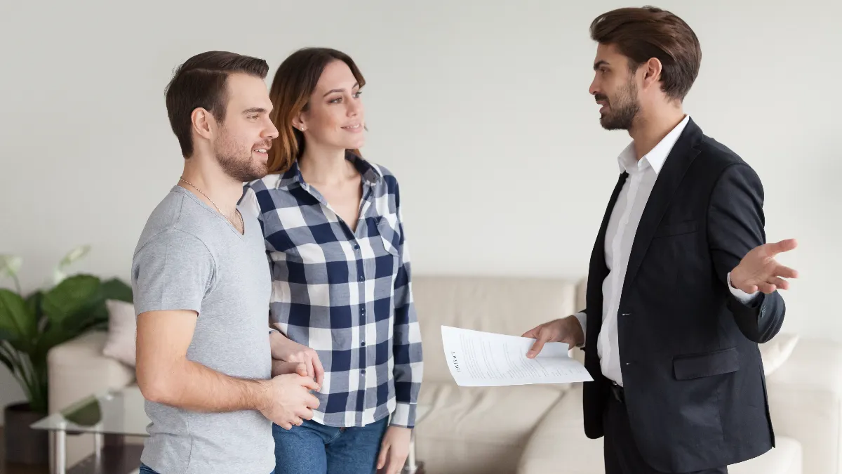 Landlord consulting, explaining terms of contract to tenants